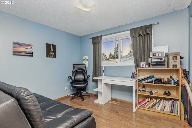 5355 SW 205th Ct, Beaverton, OR 97078 - office area featuring wood finished floors, a textured ceiling, and baseboards