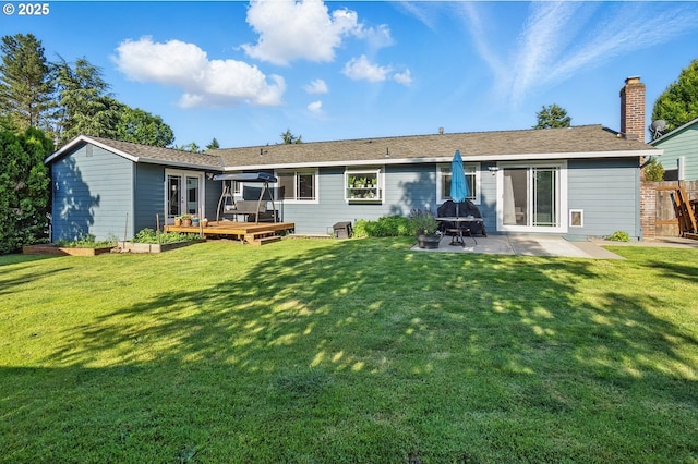 5355 SW 205th Ct, Beaverton, OR 97078 - rear view of property featuring a wooden deck, a patio area, and a chimney
