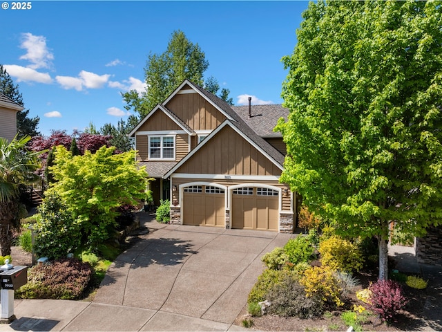 craftsman inspired home with stone siding, concrete driveway, board and batten siding, and roof with shingles