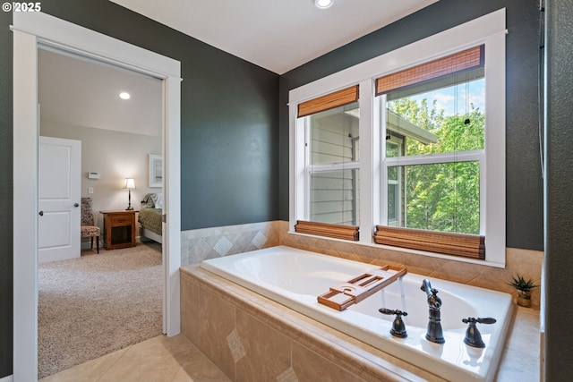 ensuite bathroom featuring a bath, tile patterned flooring, and recessed lighting