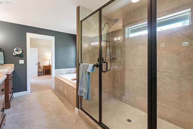 ensuite bathroom with a shower stall, vanity, a garden tub, and tile patterned floors