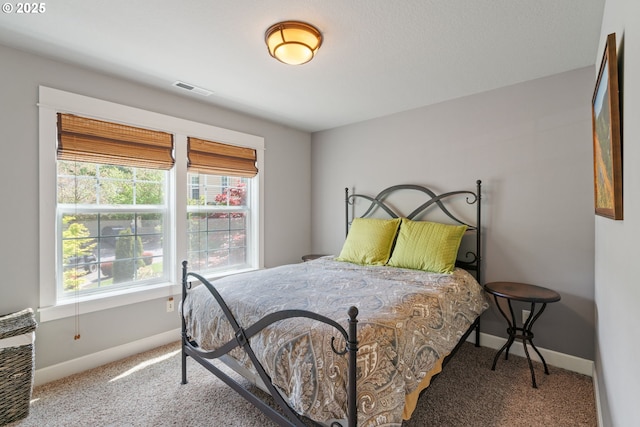 bedroom featuring carpet floors and baseboards