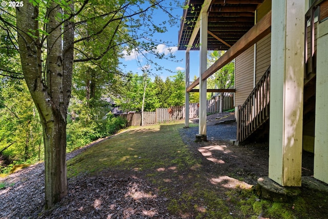 view of yard featuring stairs and fence