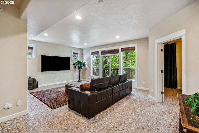 carpeted living room with plenty of natural light, recessed lighting, and baseboards
