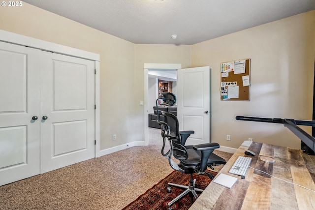 carpeted office space featuring baseboards