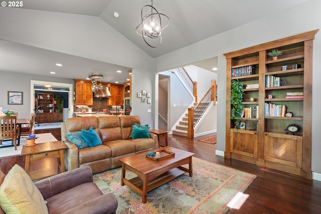 living room featuring lofted ceiling, wood finished floors, recessed lighting, stairway, and a chandelier