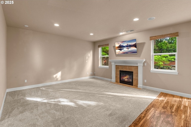 unfurnished living room with recessed lighting, baseboards, visible vents, and a healthy amount of sunlight