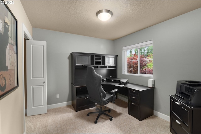 office with baseboards, light carpet, and a textured ceiling