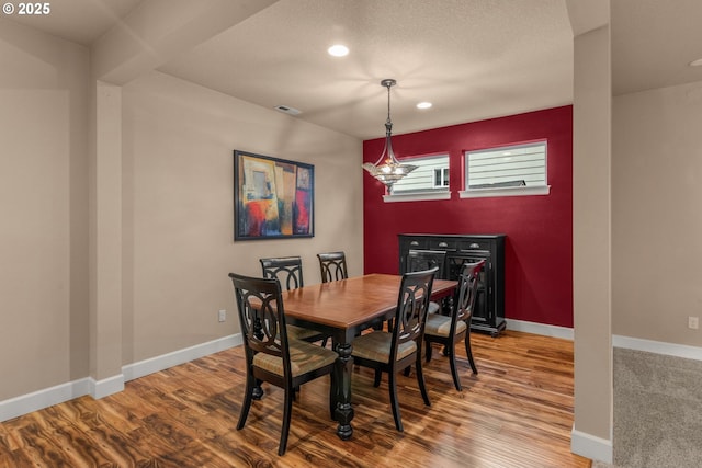 dining space featuring baseboards, recessed lighting, wood finished floors, and visible vents