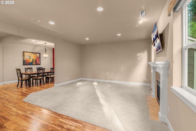 1043 Meek Way W, Linn, OR 97068 - unfurnished living room with recessed lighting, healthy amount of natural light, a fireplace with flush hearth, and baseboards