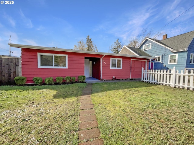 view of front of property featuring an attached garage, a front yard, and fence