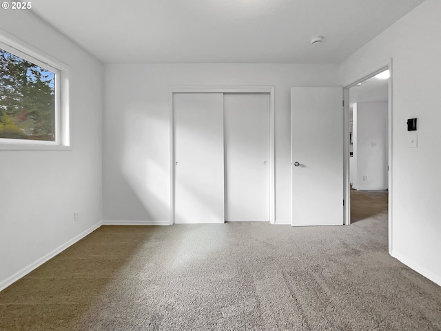 unfurnished bedroom with a closet and baseboards