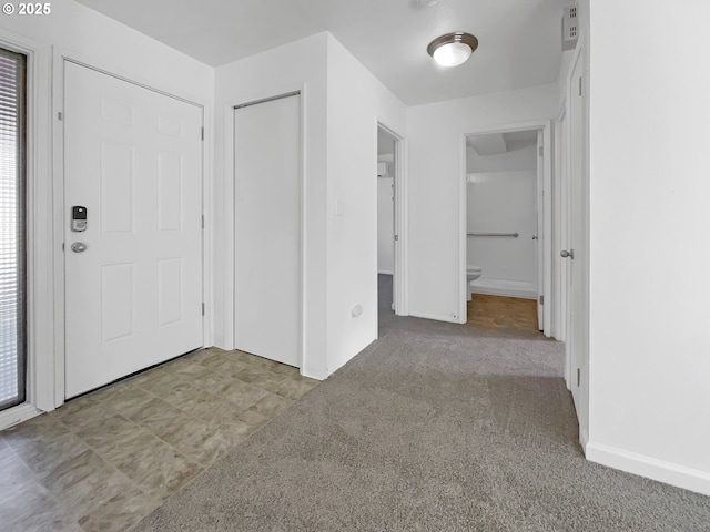 view of carpeted foyer entrance