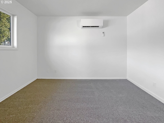 empty room featuring baseboards and a wall mounted air conditioner