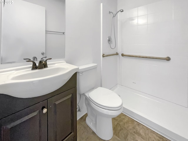 bathroom with a shower, toilet, and vanity