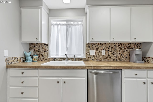 kitchen featuring tasteful backsplash, dishwasher, sink, and white cabinets