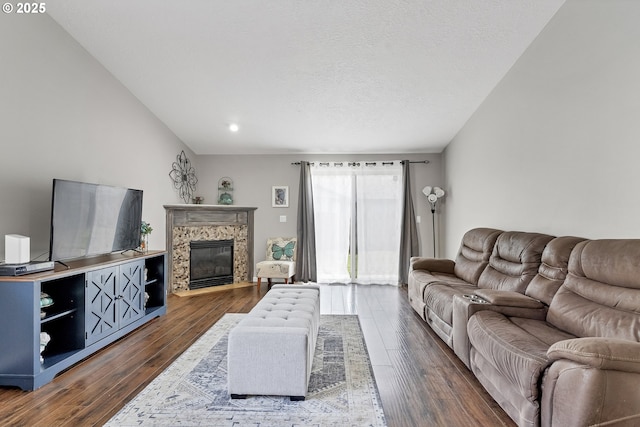 living room featuring dark hardwood / wood-style floors, a textured ceiling, and a high end fireplace