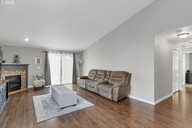 living room featuring dark wood-type flooring and a high end fireplace