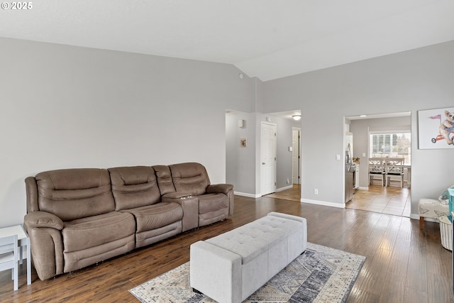 living room with vaulted ceiling and hardwood / wood-style floors