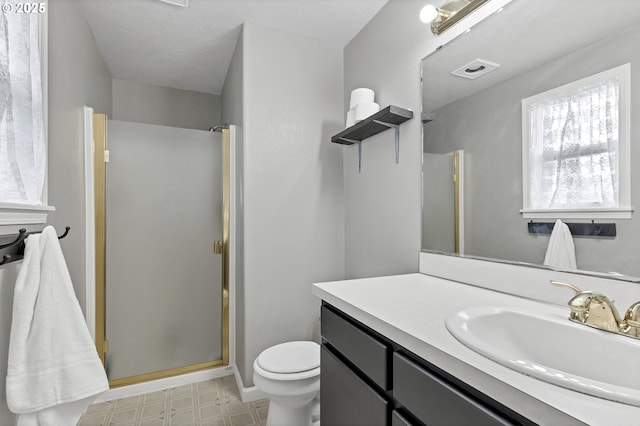 bathroom featuring walk in shower, vanity, and toilet