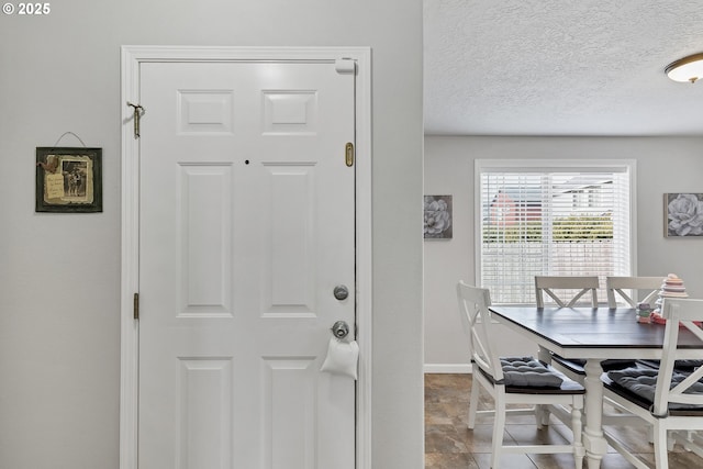 dining space with a textured ceiling