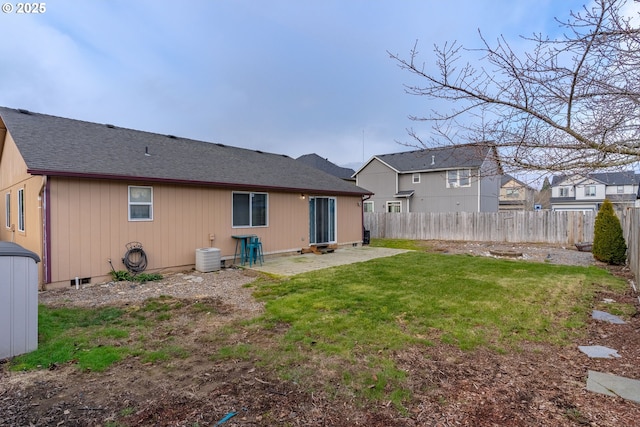 rear view of property with a lawn, a patio, and central air condition unit