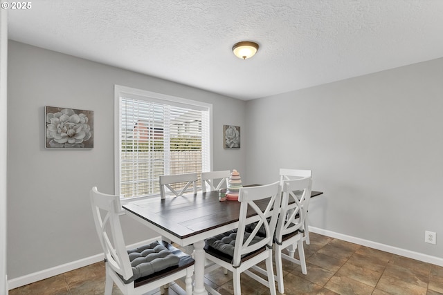 dining room featuring a textured ceiling