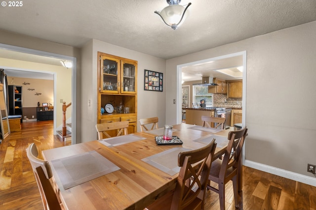 dining room with a textured ceiling and hardwood / wood-style flooring