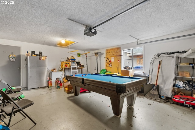 rec room with pool table, a textured ceiling, and concrete floors