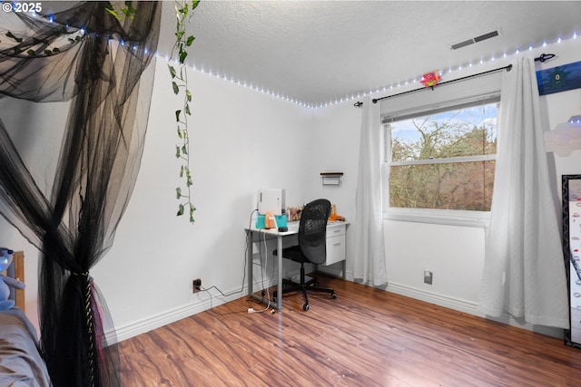 office space with a textured ceiling and hardwood / wood-style flooring