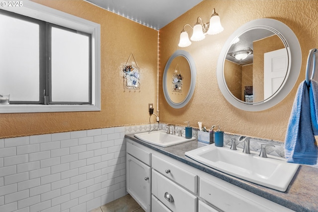 bathroom featuring tile walls, tile patterned flooring, and vanity