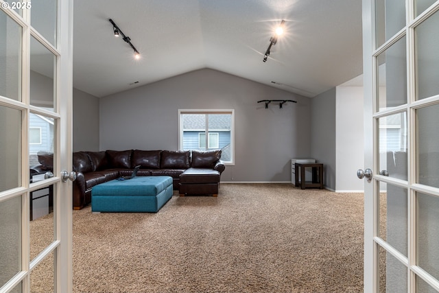 352 SE 14th Pl, Canby, OR 97013 - living area featuring french doors, rail lighting, carpet flooring, lofted ceiling, and baseboards