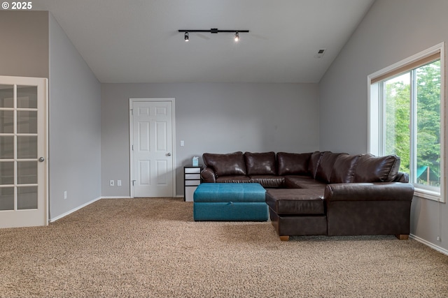 352 SE 14th Pl, Canby, OR 97013 - carpeted living room featuring rail lighting, vaulted ceiling, and baseboards