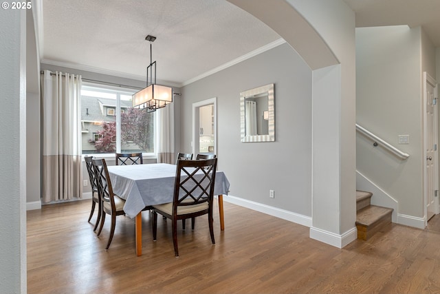 352 SE 14th Pl, Canby, OR 97013 - dining room featuring ornamental molding, a chandelier, wood finished floors, stairs, and baseboards