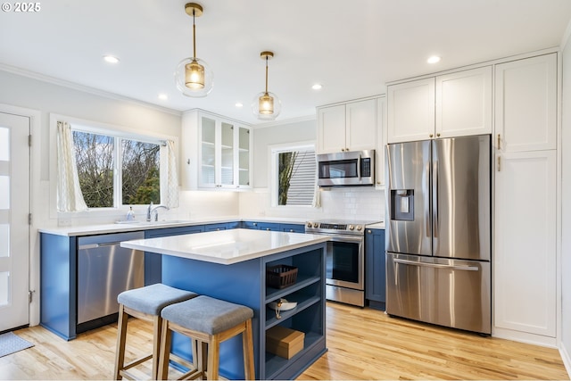 kitchen with white cabinetry, light countertops, appliances with stainless steel finishes, open shelves, and glass insert cabinets