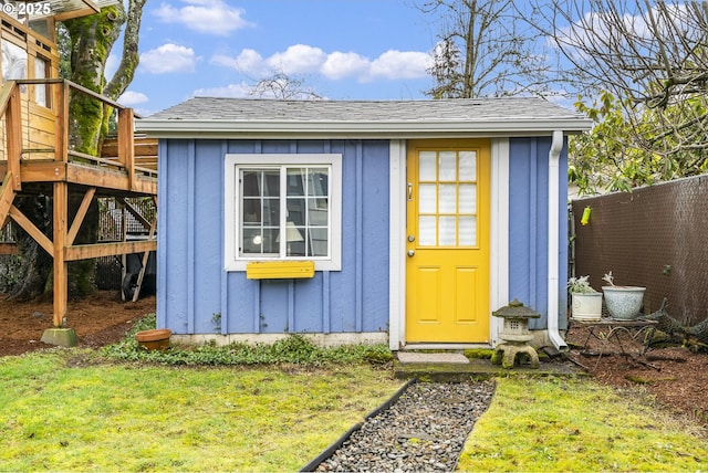 view of shed featuring fence