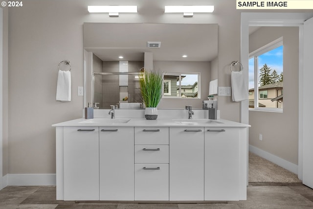 bathroom featuring double vanity, a sink, visible vents, and a shower stall