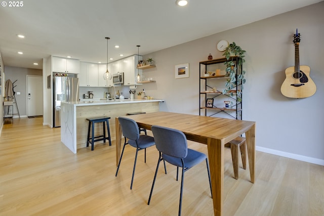 6825 SW Capitol Hill Rd Unit 27, Portland, OR 97219 - dining space with light wood-style flooring and recessed lighting