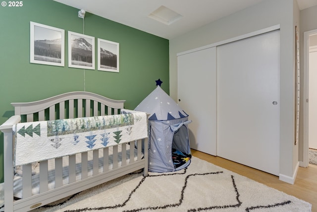 6825 SW Capitol Hill Rd Unit 27, Portland, OR 97219 - bedroom with wood finished floors, a closet, and attic access