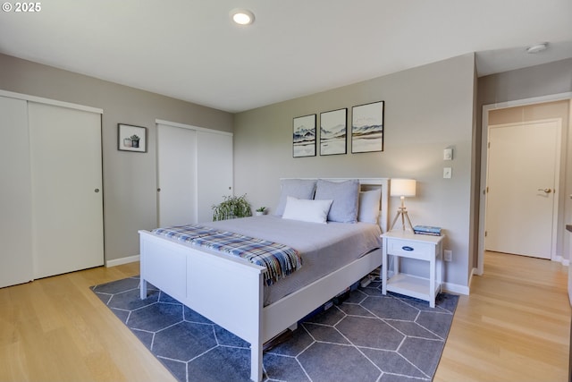 6825 SW Capitol Hill Rd Unit 27, Portland, OR 97219 - bedroom featuring wood finished floors, multiple closets, and recessed lighting