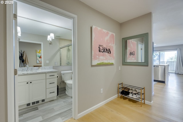 6825 SW Capitol Hill Rd Unit 27, Portland, OR 97219 - corridor featuring light wood finished floors and an upstairs landing