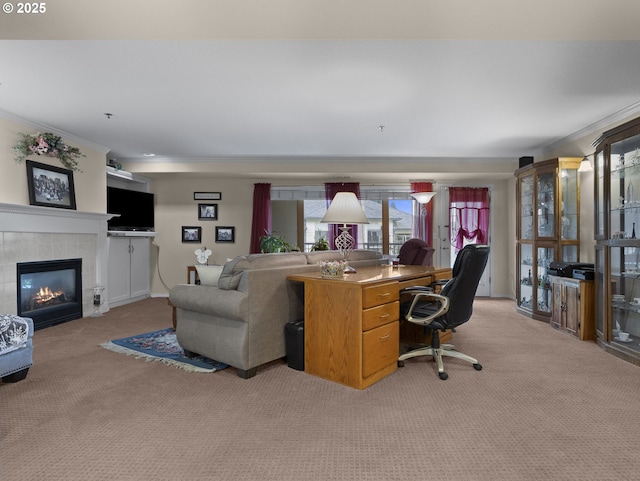 carpeted living room featuring a tile fireplace and crown molding