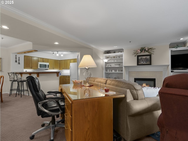 living room with crown molding, a tile fireplace, carpet floors, and rail lighting