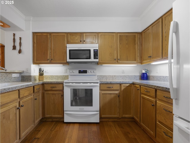 kitchen featuring sink, white appliances, ornamental molding, and dark hardwood / wood-style flooring