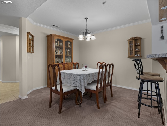 dining room featuring light colored carpet, ornamental molding, and an inviting chandelier