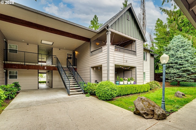 14019 NE 20th Ave Unit E44, Vancouver, WA 98686 - view of property with concrete driveway, stairway, and an attached carport