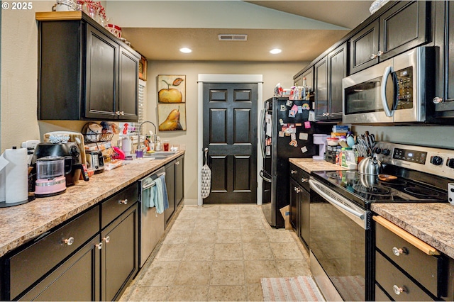 14019 NE 20th Ave Unit E44, Vancouver, WA 98686 - kitchen with stainless steel appliances, a sink, lofted ceiling, light countertops, and recessed lighting