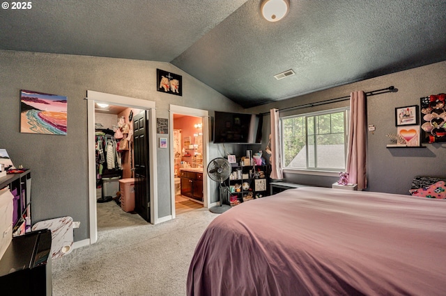 14019 NE 20th Ave Unit E44, Vancouver, WA 98686 - bedroom featuring lofted ceiling, a spacious closet, carpet, ensuite bathroom, and a textured wall