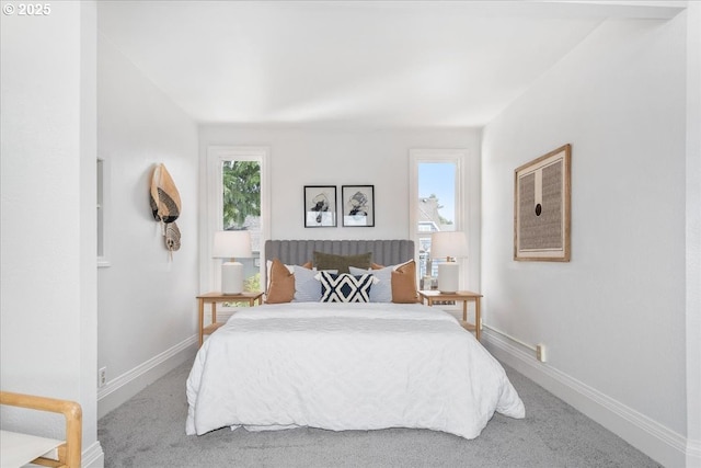 carpeted bedroom featuring baseboards