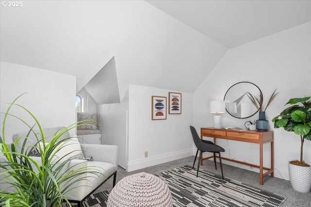 carpeted office space featuring baseboards and lofted ceiling